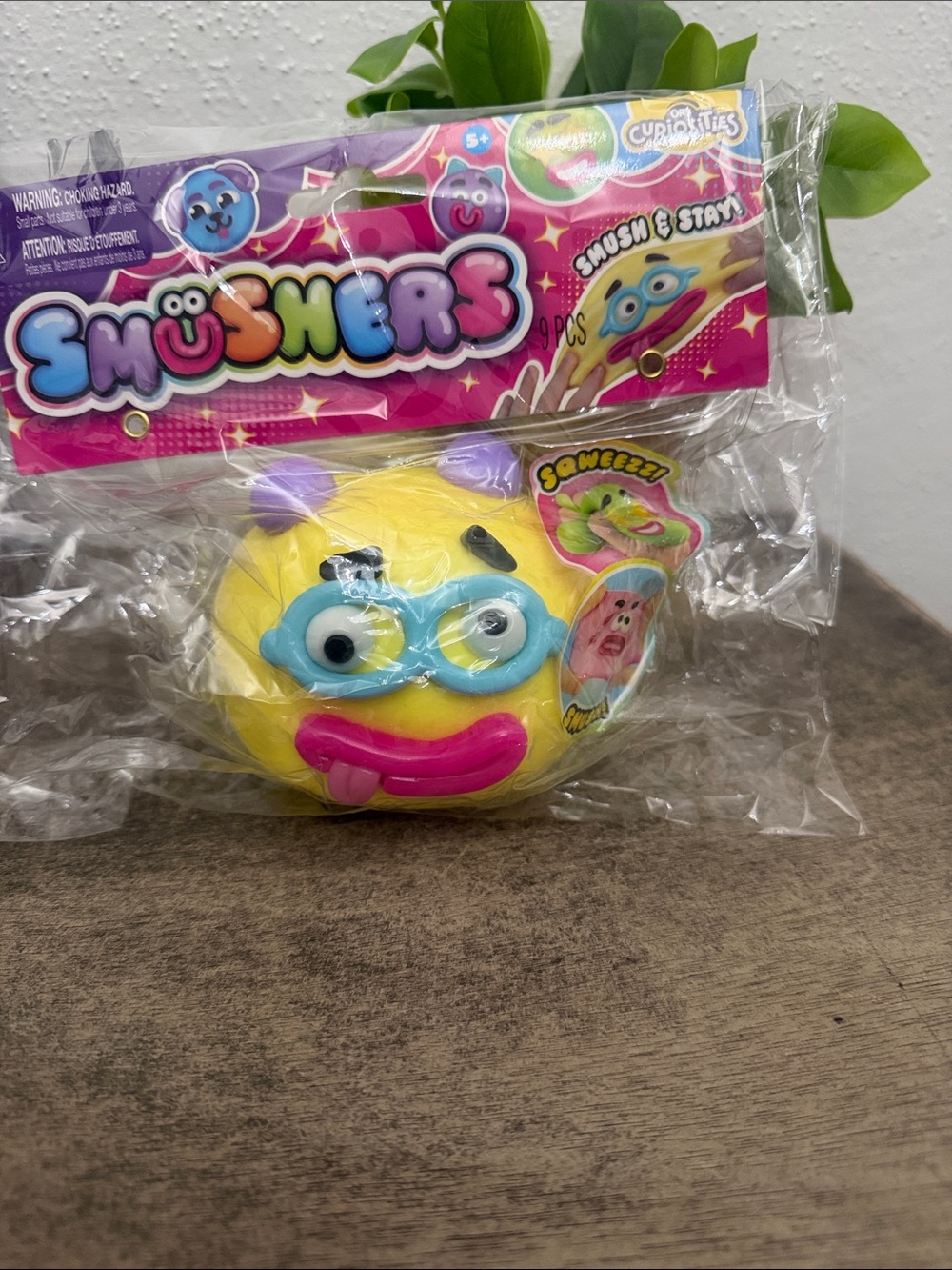 SmUsher Yellow Emoji Squishy Toy with Pink Mouth and Blue Goggles